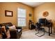 Well-lit home office with a desk, leather chair, and natural light from the window at 6049 Royal Gate Pl, Indianapolis, IN 46237