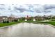 Scenic view of the home's location near a pond, complemented by beautifully landscaped surroundings and neighborhood charm at 6049 Royal Gate Pl, Indianapolis, IN 46237