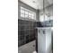 Modern tiled shower stall with glass surround, window, and dual shower heads at 6049 Royal Gate Pl, Indianapolis, IN 46237
