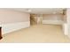 Large finished basement featuring neutral carpeting, wainscoting, and ample space for activities at 611 Mill Farm Rd, Noblesville, IN 46062