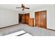This bedroom has a light carpet, a ceiling fan, closet, and a wooden dresser at 611 Mill Farm Rd, Noblesville, IN 46062