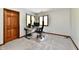 This office has light carpet, two windows, and a desk setup with a computer and chair at 611 Mill Farm Rd, Noblesville, IN 46062