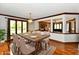 Elegant dining room featuring a wooden table, chandelier, and large windows overlooking the yard at 611 Mill Farm Rd, Noblesville, IN 46062