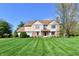 Charming two-story home featuring a well-manicured lawn and a classic facade with brick and siding accents at 611 Mill Farm Rd, Noblesville, IN 46062