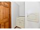 Hallway featuring a white storage cabinet next to a brown door at 611 Mill Farm Rd, Noblesville, IN 46062