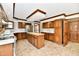 Charming kitchen featuring wood cabinets, a tile island, and stainless steel appliances at 611 Mill Farm Rd, Noblesville, IN 46062