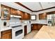 Well-equipped kitchen with wood cabinetry, white appliances, and ample counter space at 611 Mill Farm Rd, Noblesville, IN 46062
