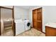 Functional laundry room with washer, dryer, storage closet, and utility sink at 611 Mill Farm Rd, Noblesville, IN 46062