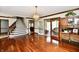 Spacious living room featuring hardwood floors, staircase, and glass doors to sunroom at 611 Mill Farm Rd, Noblesville, IN 46062