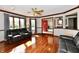 Comfortable living room featuring hardwood floors, a ceiling fan, and a large window at 611 Mill Farm Rd, Noblesville, IN 46062