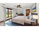 Comfortable main bedroom with a large window, ceiling fan, and stylish decor at 611 Mill Farm Rd, Noblesville, IN 46062