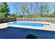 Sparkling in-ground pool surrounded by a concrete patio and wood fence at 611 Mill Farm Rd, Noblesville, IN 46062