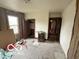 Bedroom under renovation with exposed walls, original floors, and natural light at 629 E 32Nd St, Anderson, IN 46016