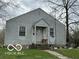 Quaint home with neutral siding, a gabled roof, and a covered front entry at 629 E 32Nd St, Anderson, IN 46016