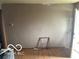 Empty room with a partially exposed wall, plain hardwood floors and a door to the outside at 629 E 32Nd St, Anderson, IN 46016