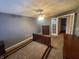 Bedroom featuring wooden bedroom furniture and a ceiling fan, with a view to a sunroom at 6525 Emerald Hill Ct # 208, Indianapolis, IN 46237