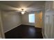 Cozy bedroom featuring a ceiling fan and neutral walls, next to a window at 6525 Emerald Hill Ct # 208, Indianapolis, IN 46237