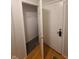 Hallway showing a carpeted closet with wire shelving to the left of a solid white door at 6525 Emerald Hill Ct # 208, Indianapolis, IN 46237