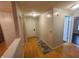 Inviting hallway with hardwood floors leading to various rooms and a white front door at 6525 Emerald Hill Ct # 208, Indianapolis, IN 46237