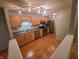 Well-lit kitchen with stainless steel appliances, sleek countertops, and hardwood flooring at 6525 Emerald Hill Ct # 208, Indianapolis, IN 46237