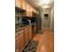 Efficient kitchen layout, featuring stainless steel appliances and natural wood cabinets at 6525 Emerald Hill Ct # 208, Indianapolis, IN 46237