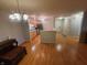 Spacious layout featuring hardwood floors, updated lighting, and an open view to the kitchen at 6525 Emerald Hill Ct # 208, Indianapolis, IN 46237