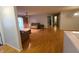 Bright living room with hardwood floors, neutral paint, and sliding doors to a balcony at 6525 Emerald Hill Ct # 208, Indianapolis, IN 46237