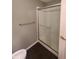 Modern shower features frameless glass doors, grab bars, and sleek fixtures at 6525 Emerald Hill Ct # 208, Indianapolis, IN 46237