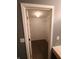 Bright walk-in closet with a single lightbulb and shelving for plenty of space to organize your wardrobe at 6525 Emerald Hill Ct # 208, Indianapolis, IN 46237