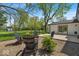 Inviting backyard with a cozy seating area, mature trees, and well-maintained landscaping at 7205 Steven Ln, Indianapolis, IN 46260