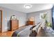 Bedroom featuring hardwood floors, natural light, neutral color scheme, dresser, and comfortable decor at 7205 Steven Ln, Indianapolis, IN 46260