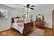 Inviting bedroom with hardwood floors, vintage furniture, and plenty of natural light at 7205 Steven Ln, Indianapolis, IN 46260