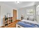 Well-lit bedroom boasts hardwood floors, natural light, and ample closet space at 7205 Steven Ln, Indianapolis, IN 46260