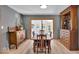 Classic dining room with a wooden dining set and large windows to the backyard at 7205 Steven Ln, Indianapolis, IN 46260