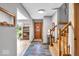 Inviting entryway featuring a slate floor, wooden staircase, and tasteful decor, creating a warm and welcoming atmosphere at 7205 Steven Ln, Indianapolis, IN 46260