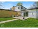 Exterior showcasing a blend of brick and siding, a cozy swing, and a lush green lawn at 7205 Steven Ln, Indianapolis, IN 46260