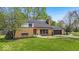 Charming brick home featuring a well-manicured lawn and attached garage, perfect for comfortable suburban living at 7205 Steven Ln, Indianapolis, IN 46260