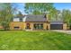 Charming brick home featuring a well-manicured lawn and attached garage, perfect for comfortable suburban living at 7205 Steven Ln, Indianapolis, IN 46260