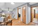 Inviting hallway showcasing hardwood floors, chair, and access to multiple rooms at 7205 Steven Ln, Indianapolis, IN 46260
