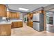 Spacious kitchen with stainless steel refrigerator, oak cabinets, and wood-look flooring at 7205 Steven Ln, Indianapolis, IN 46260