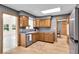 Well-lit kitchen with wooden cabinets, stainless steel appliances, and wood-look flooring at 7205 Steven Ln, Indianapolis, IN 46260