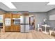 Open kitchen layout with stainless appliances, wood cabinets, and bright overhead lighting at 7205 Steven Ln, Indianapolis, IN 46260