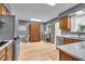 Kitchen with stainless steel appliances, light wood-look floors, and breakfast nook at 7205 Steven Ln, Indianapolis, IN 46260