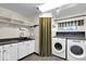 Functional laundry room with sleek countertops, modern appliances, and ample storage at 7205 Steven Ln, Indianapolis, IN 46260