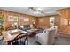 Cozy living area featuring classic wood paneling, plush seating, and ample natural light at 7205 Steven Ln, Indianapolis, IN 46260
