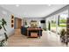 Bright living room with hardwood floors, fireplace, and large windows overlooking the lawn at 7205 Steven Ln, Indianapolis, IN 46260