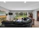 Bright living room featuring a fireplace, large window with backyard view, and stylish decor, creating a cozy atmosphere at 7205 Steven Ln, Indianapolis, IN 46260