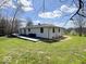 Exterior view of the house with a large deck and spacious backyard, perfect for outdoor activities at 7440 S 250 W, Pendleton, IN 46064
