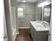 Bathroom featuring a double sink vanity with stylish fixtures and a shower-tub at 7440 S 250 W, Pendleton, IN 46064