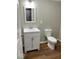 Well-lit bathroom features a white vanity with shaker-style doors and a matching framed mirror at 7440 S 250 W, Pendleton, IN 46064